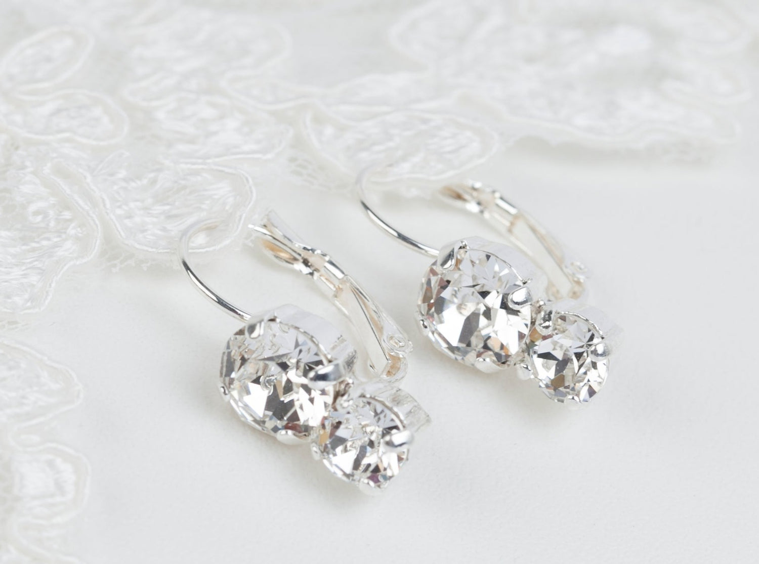 A pair of crystal leverback earrings in a style  for brides or bridesmaids. Two sparkling Austrian crystals hang frrom the earrings in a simple design that is not too large or heavy.